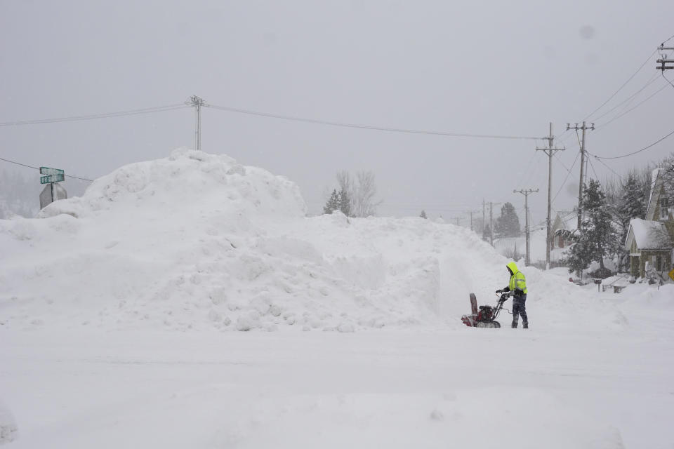 A man uses a snow blower as snow piles up during a storm, Sunday, March 3, 2024, in Truckee, Calif. (AP Photo/Brooke Hess-Homeier)