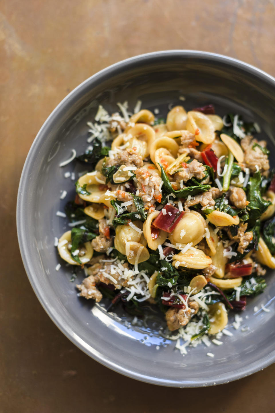 This image released by Milk Street shows a recipe for orecchiette with sausage and arugula. (Milk Street via AP)