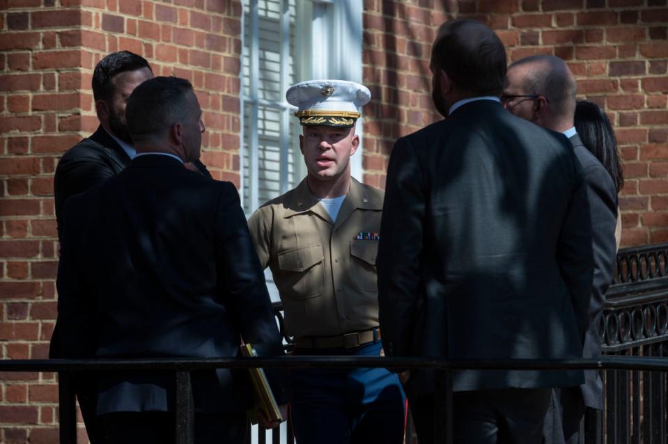 US Marine Corp Major Joshua Mast, center, talks with his attorneys (Copyright 2023 the Associated Press. All Rights Reserved)