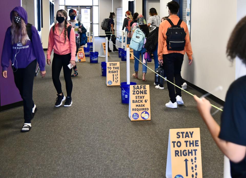 Students change classes recently at Booker High School in Sarasota, Fla., where measures have been taken across the campus to facilitate social distancing.
