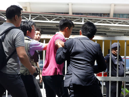 Media journalists scuffle with a North Korean official (in pink) as they try for a door stop at the morgue at Kuala Lumpur General Hospital where Kim Jong Nam's body is held for autopsy in Malaysia February 15, 2017. REUTERS/Edgar Su