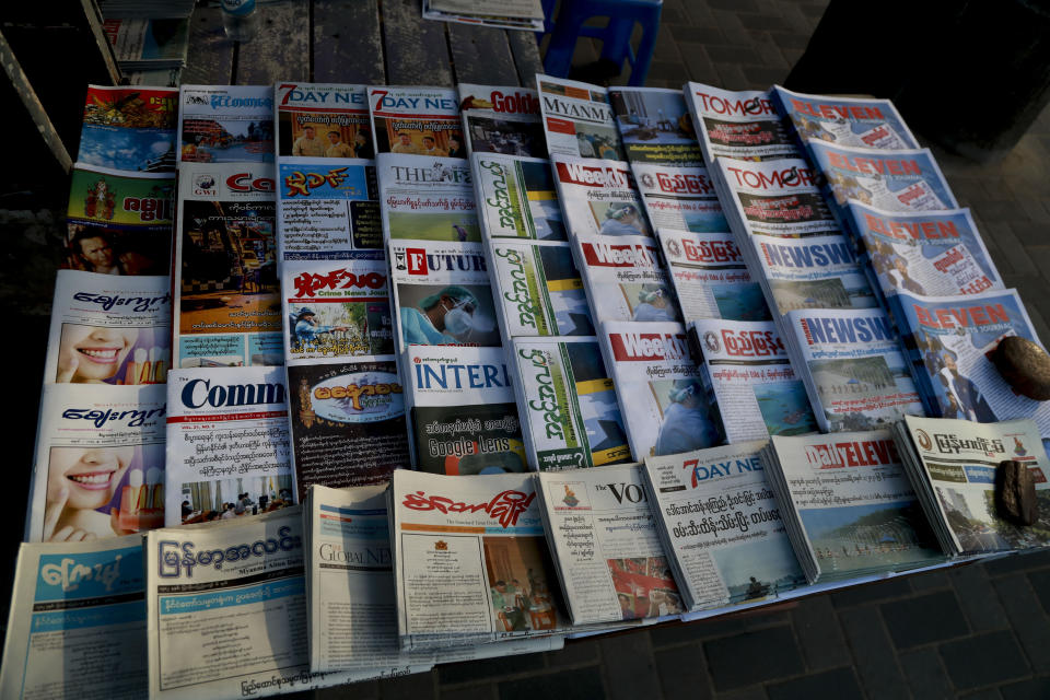 Newspapers are displayed in a newspaper stall in Yangon, Myanmar, Tuesday, Feb. 2, 2021. Hundreds of members of Myanmar's Parliament remained confined inside their government housing in the country's capital on Tuesday, a day after the military staged a coup and detained senior politicians including Nobel laureate and de facto leader Aung San Suu Kyi. (AP Photo/Thein Zaw)