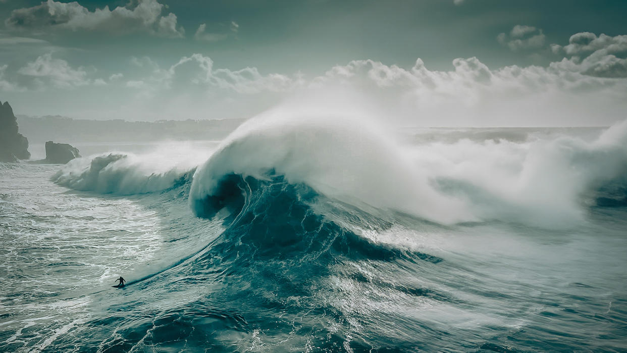 Huge wave cresting with tons of blue and white water