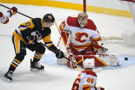 Calgary Flames goaltender Jacob Markstrom (25) blocks a shot by Pittsburgh Penguins' Drew O'Connor (10) during the first period of an NHL hockey game in Pittsburgh, Thursday, Oct. 28, 2021. (AP Photo/Gene J. Puskar)