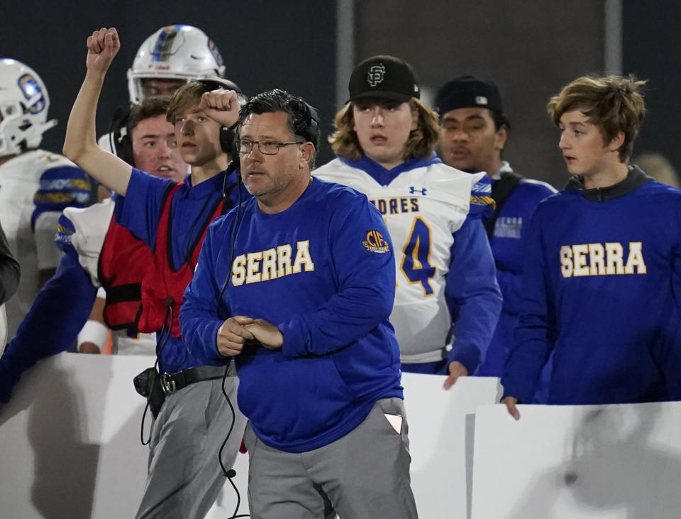 FILE - Junipero Serra High School coach Patrick Walsh of watches a play during the first half of the 2021 CIF Open Division high school football state championship game Saturday, Dec. 11, 2021, in Mission Viejo Calif. Walsh, says prospects at his school have become more open to considering programs from outside the West Coast. (AP Photo/Ashley Landis, File)