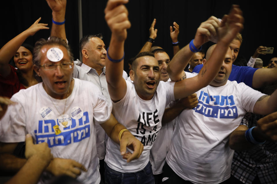 Israeli Prime Minister Benjamin Netanyahu supporters chant as the await results of the elections in Tel Aviv, Israel, Tuesday, Sept. 17, 2019. (AP Photo/Ariel Schalit)