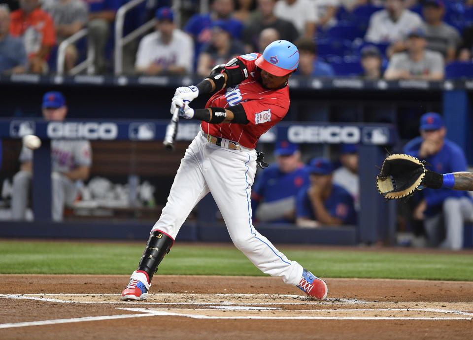 Miami Marlins' Luis Arraez singles to left field during the first inning of a baseball game against the New York Mets, Saturday, April 1, 2023, in Miami. (AP Photo/Michael Laughlin)