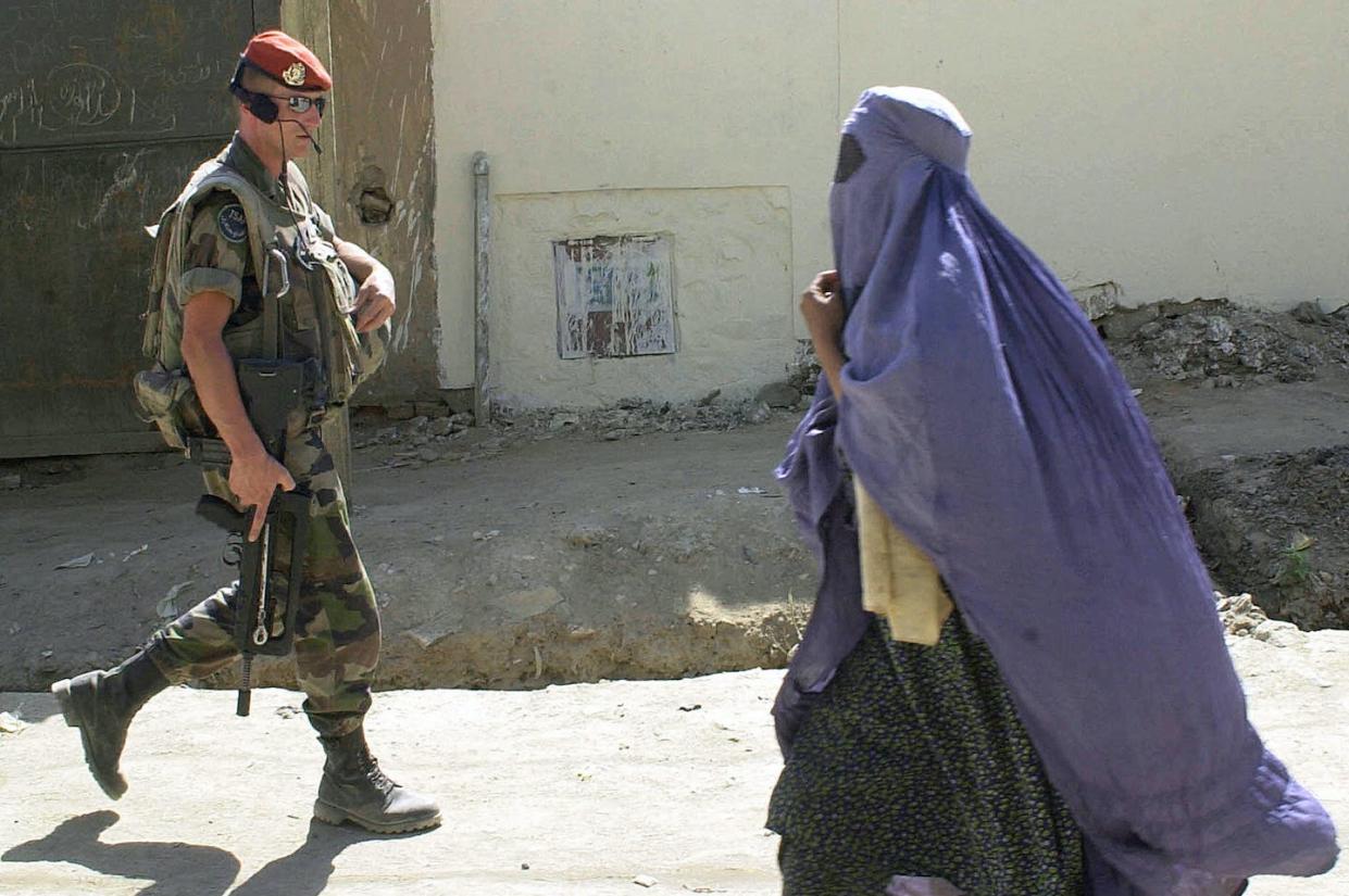 Photographs capture images of women in war-torn regions of the world. <a href="https://www.gettyimages.com/detail/news-photo/file-picture-showing-an-afghan-woman-passing-by-a-french-news-photo/55712325?phrase=afghan%20women%20war&adppopup=true" rel="nofollow noopener" target="_blank" data-ylk="slk:SHAH MARAI/AFP via Getty Images;elm:context_link;itc:0;sec:content-canvas" class="link ">SHAH MARAI/AFP via Getty Images</a>