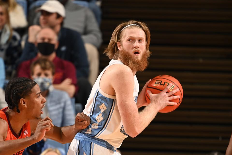 Jan 26, 2022; Chapel Hill, North Carolina, USA;  North Carolina Tar Heels forward Brady Manek (45) with the ball as Virginia Tech Hokies forward David N'Guessan (1) defends in the first half at Dean E. Smith Center.