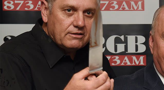 Ray Hadley pictured helping Alan Jones cut a cake at a 2GB celebration in 2014. Photo: AAP