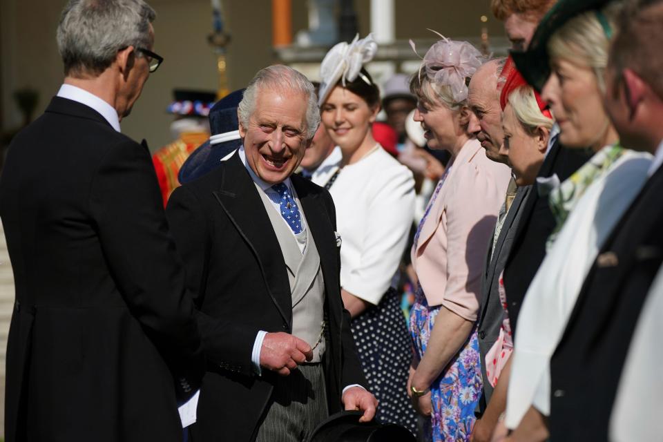 Britain's King Charles III speaks with guests, during a Garden Party at Buckingham Palace, London, Wednesday, May 3, 2023, in celebration of the coronation on May 6. (Yui Mok/Pool via AP)