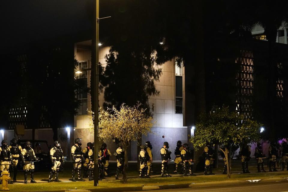 Riot police surround the Arizona Capitol after protesters reached the front of the Arizona Sentate building following the Supreme Court's decision to overturn Roe v. Wade Friday, June 24, 2022, in Phoenix. (AP Photo/Ross D. Franklin)