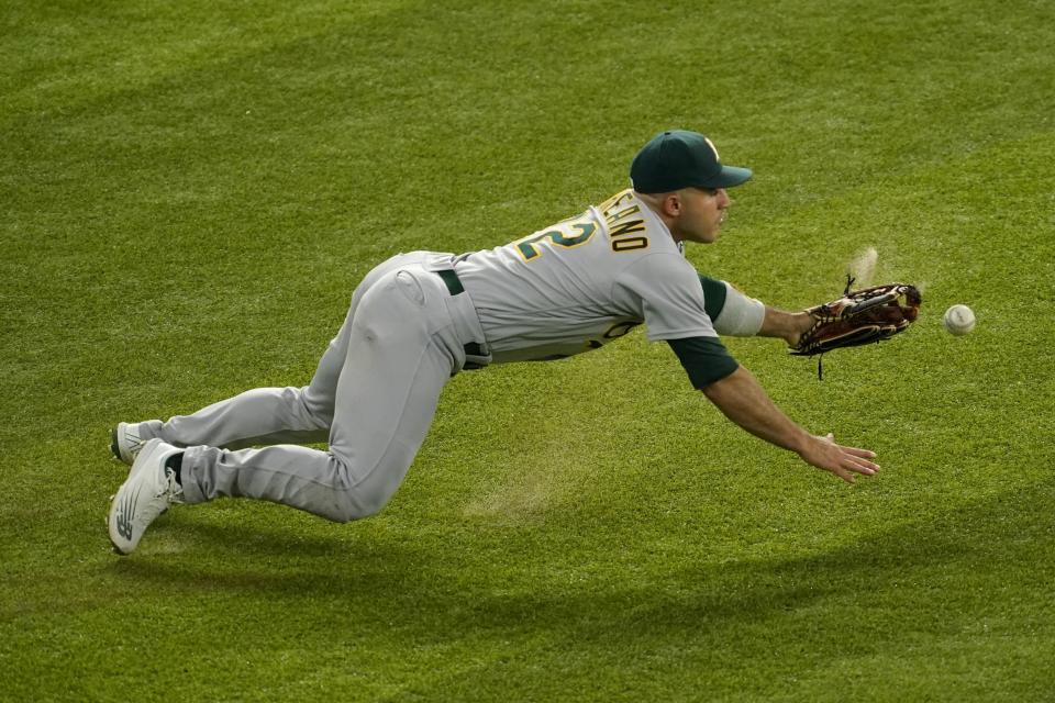 Oakland Athletics right fielder Ramon Laureano is unable to reach a two-run single by Texas Rangers' Brad Miller in the first inning of a baseball game, Wednesday, July 13, 2022, in Arlington, Texas. Miller was thrown out at second attempting to advance on the hit. (AP Photo/Tony Gutierrez)