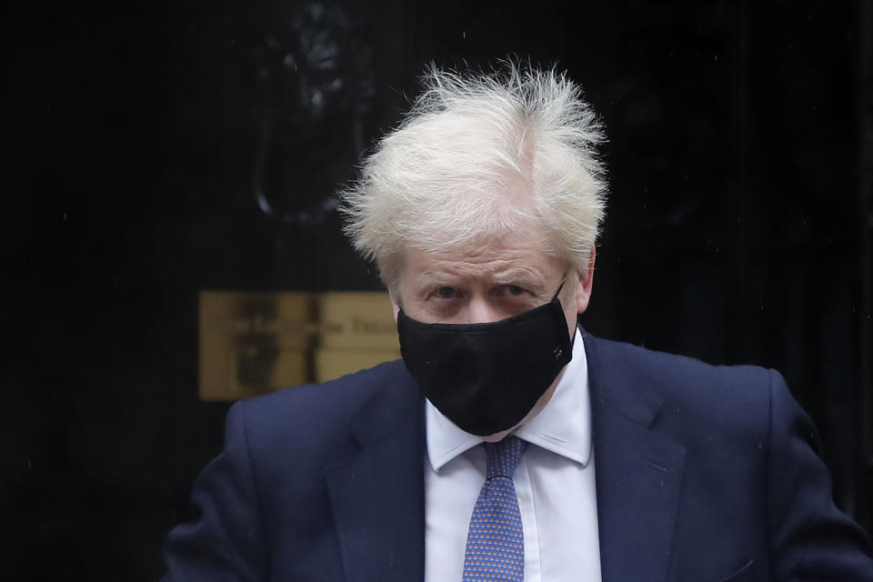 Britain's Prime Minister Boris Johnson leaves Downing Street to attend the weekly session of Prime Ministers Questions at Parliament in London, Wednesday, Oct. 21, 2020. The European Union is taking a defiant tone as the standoff over resuming post-Brexit trade negotiations with the United Kingdom continues. The bloc told London Wednesday that "you cannot have your cake and eat it too." (AP Photo/Frank Augstein)