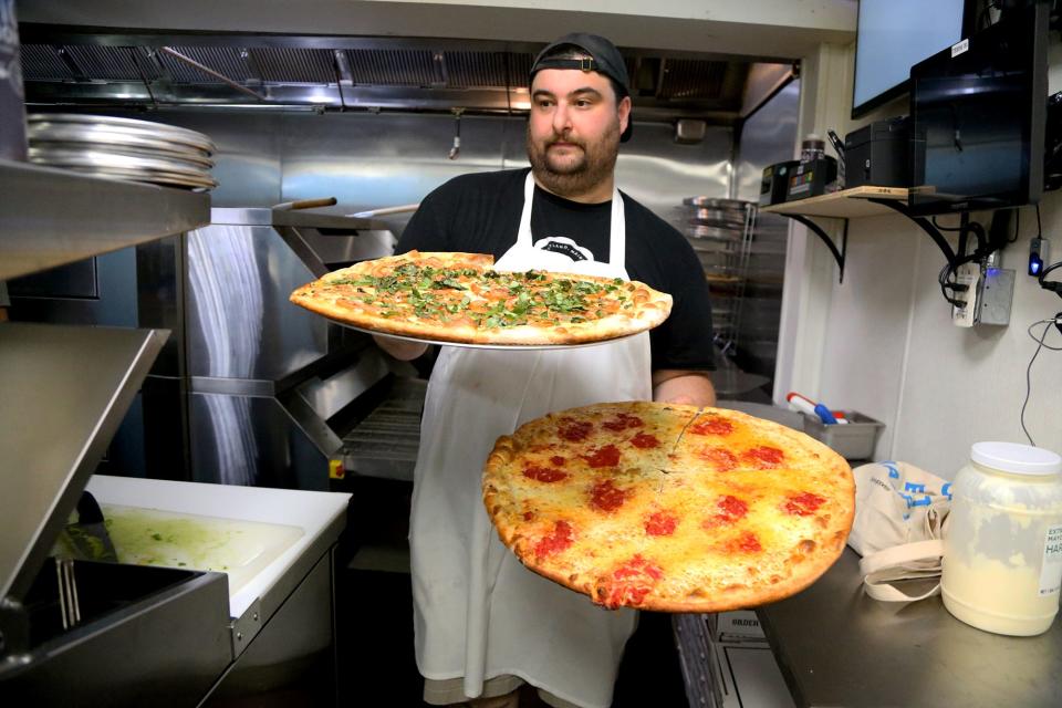 Owner Alex Budd cooks pizzas during the opening of Otto Pizza in Exeter on Monday, Sept. 12, 2022.