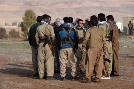 Members of the Democratic Party of Iranian Kurdistan (PDKI) gather during a funeral of victims who were killed in a bomb attack at the offices of the PDKI in Koy Sanjak, east of Erbil, Iraq, December 21, 2016. REUTERS/Azad Lashkari