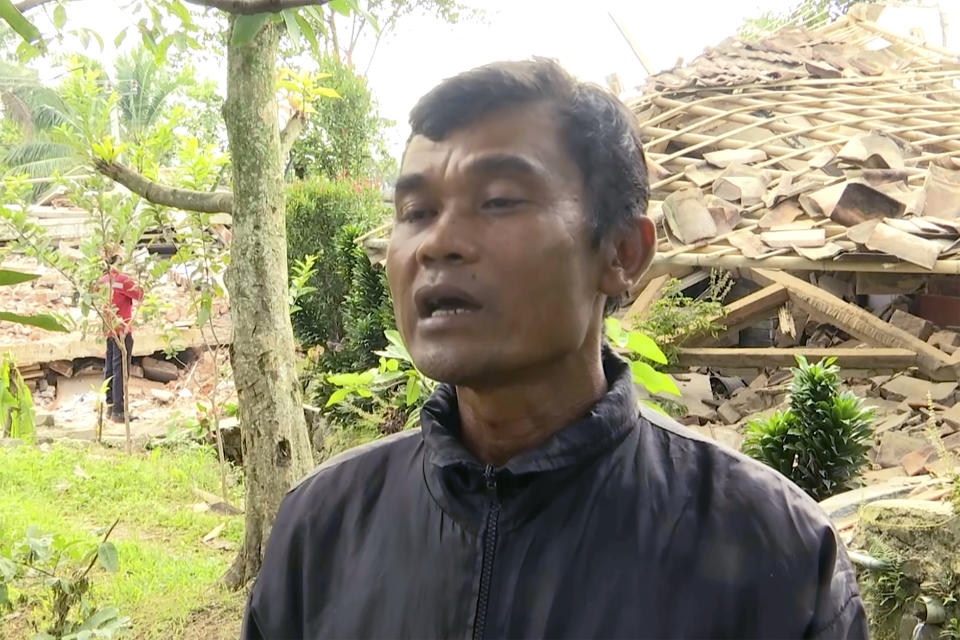 In this image taken from video, Enjot, 45 years old, describes the events during the Monday earthquake that hit his village of Cijendil, on Java island, Indonesia. The earthquake killed hundreds of people and left hundreds more injured and missing on Indonesia's main island. (AP Photo/Andi Jamiko)