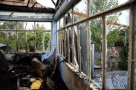 A local inspects the house hit by a rocket during the fighting over the breakaway region of Nagorno-Karabakh in the village of Baharli