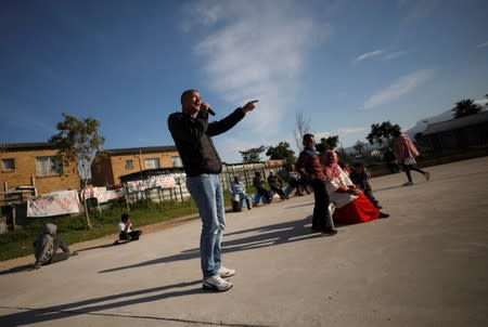 Community members gather in a park to discuss gang violence in Manenberg township, Cape Town