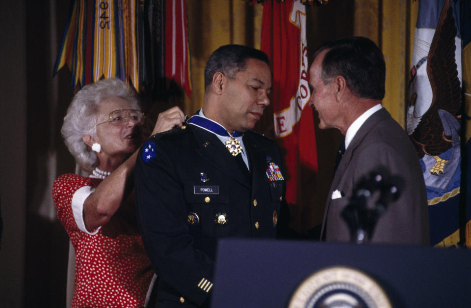 Colin Powell, chairman of the Joint Chiefs of Staff, receives the Presidential Medal of Freedom from President George H.W. Bush and first lady Barbara Bush.