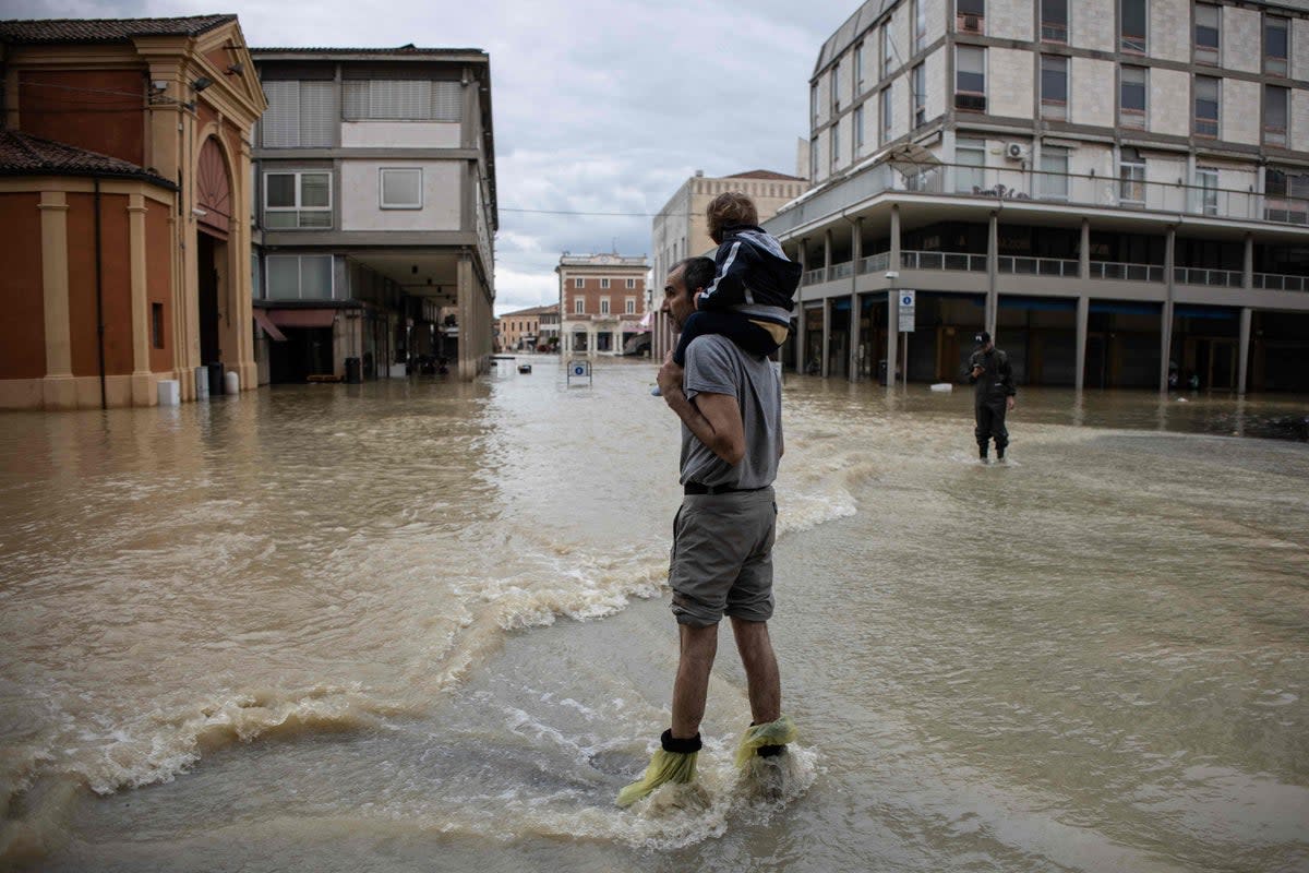 A resident carries a child in Lugo (AFP via Getty)