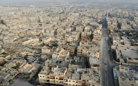 A drone picture taken on December 23 shows empty streets and damaged buildings in the town of Maaret al-Numan in the northwestern Idlib province - Credit: AFP