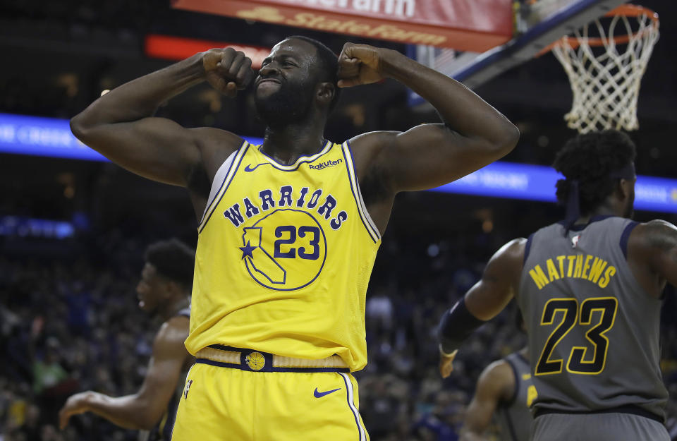 Golden State Warriors' Draymond Green, left, celebrates a score against the Indiana Pacers during the second half of an NBA basketball game Thursday, March 21, 2019, in Oakland, Calif. (AP Photo/Ben Margot)