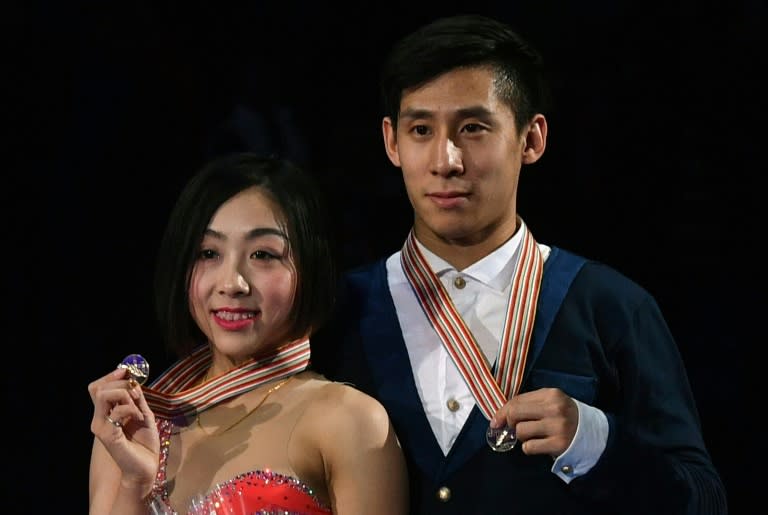 Gold medallists China's Sui Wenjing and Han Cong pose with their medals on the podium after the pairs free skating event at the ISU World Figure Skating Championships in Helsinki, Finland on March 30, 2017