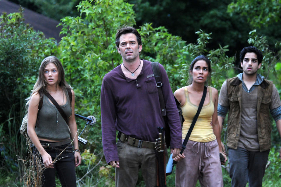 This image released by NBC shows, from left, Tracy Spiridakos as Charlie Matheson, Billy Burke as Miles Matheson, Daniella Alonso as Nora, and Paras Patel as Albert, in a scene from "Revolution." The series by J.J. Abrams tells of a world 15 years after the world inexplicably suffers a power outage. Every gadget, light source, communications means and motor vehicle is the victim of a seemingly permanent blackout. It airs Mondays at 10 p.m. EDT on NBC. (AP Photo/NBC, Brownie Harris)
