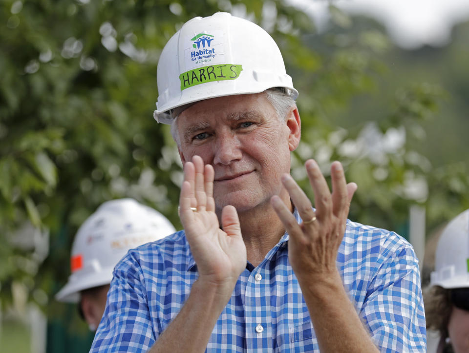 FILE - In this Sept. 26, 2018 file photo Republican congressional candidate Mark Harris applauds during a Habitat For Humanity building event in Charlotte, N.C. Harris, the Republican in the nation’s last undecided congressional election, said Monday, Feb. 11, 2019 he recruited a political operative now at the center of a ballot fraud investigation because he produced election results in his rural North Carolina county and other Republicans vouched for him. (AP Photo/Chuck Burton, file)