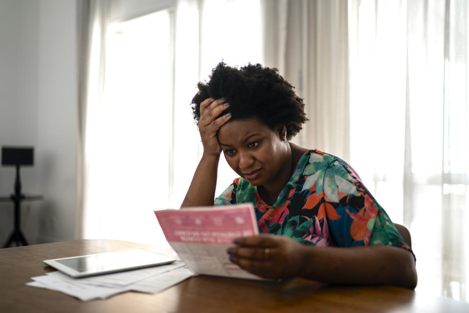 A woman looking at mail at her table