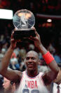 FILE - Michael Jordan holds the trophy for Most Valuable Player after the NBA All-Star game in Chicago on Feb. 7, 1988. (AP Photo/Fred Jewell, File)