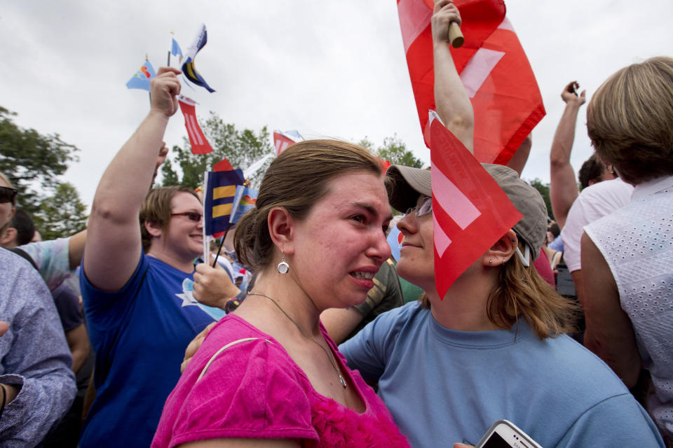 Ariel Olah of Detroit, left, and her fiancee Katie Boatman, are overcome by emotion outside the Supreme Court in Washington, Friday, June 26, 2015, as the ruling on same-sex marriage was announced. The court declared that same-sex couples have a right to marry anywhere in the US. (AP Photo/Jacquelyn Martin)