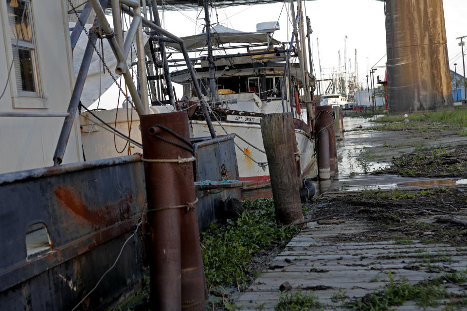 Fishing vessels are seen docked in Morgan City, La. Monday, May 11, 2020. Attempts to curb the spread of COVID-19 have visited a kind of triple economic whammy on the state. As oil prices have plummeted, the industry laid off workers. (AP Photo/Gerald Herbert)