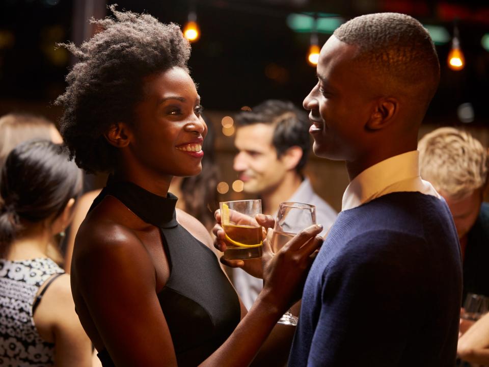 Couples Dancing And Drinking At Evening Party