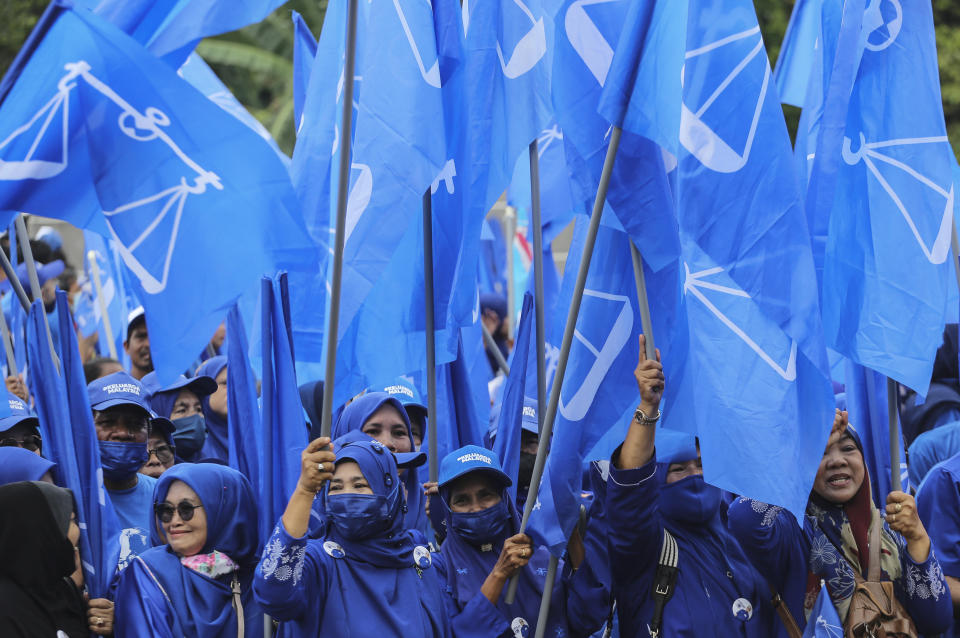 Malaysia's National Front coalition supporters cheer for Prime Minister Ismail Sabri Yaakob as he submits his nomination documents for the upcoming general election in Bera, Malaysia, Saturday, Nov. 5, 2022. (AP Photo/Ahmad Yusni)