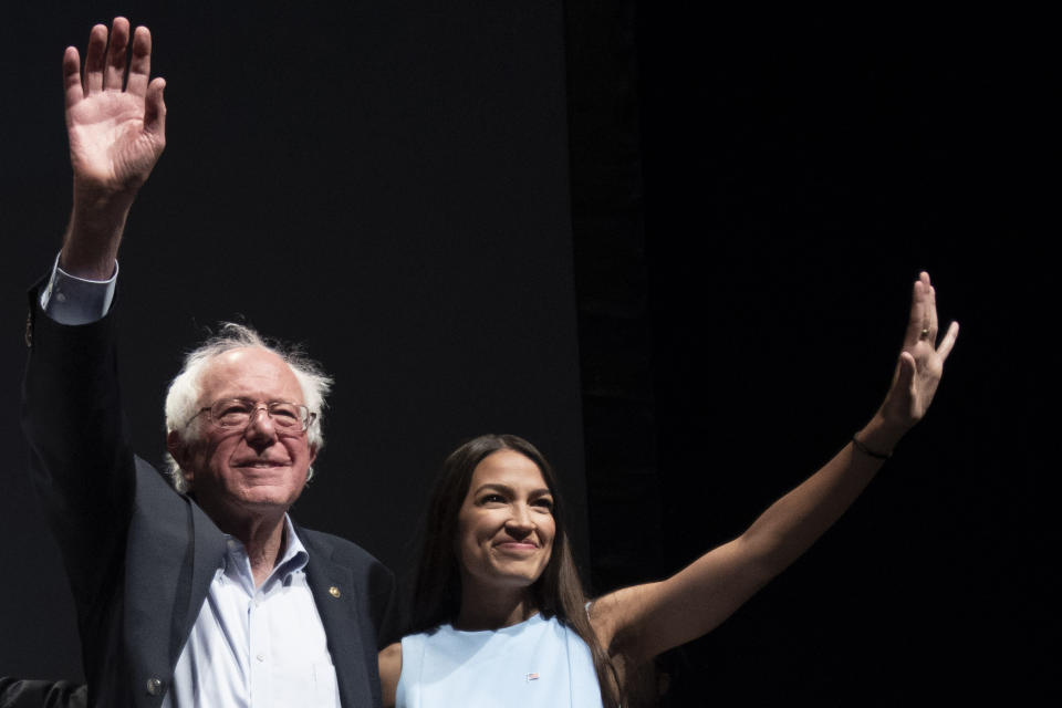 Sen. Bernie Sanders and Alexandria Ocasio-Cortez wave to the crowd at the end of a rally in Wichita, Kan., last year. (Photo: J Pat Carter for the Washington Post/Getty Images)