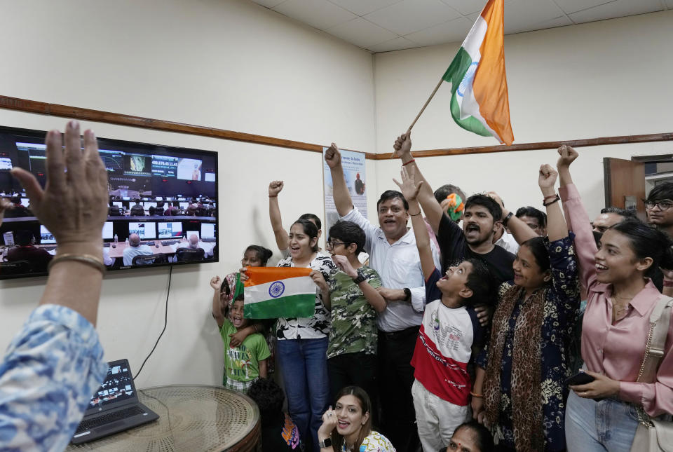 Indians celebrate the successful landing of Chandrayaan-3, or “moon craft” in Sanskrit, at the Nehru Planetarium in New Delhi, India, Wednesday, Aug. 23, 2023. India has landed a spacecraft near the moon’s south pole, an unchartered territory that scientists believe could hold vital reserves of frozen water and precious elements, as the country cements its growing prowess in space and technology. (AP Photo/Manish Swarup)