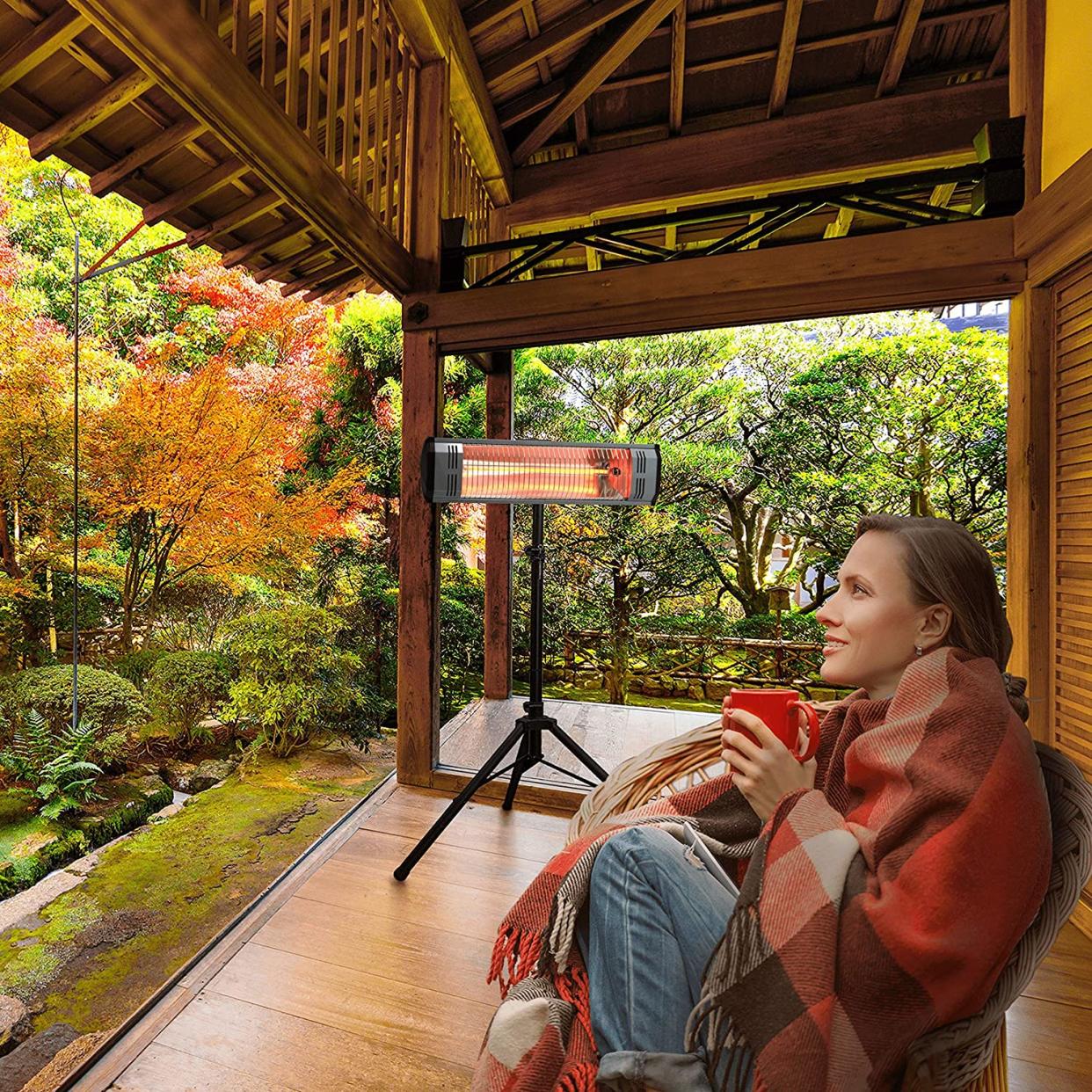 person looking at nature with a heat lamp on open patio