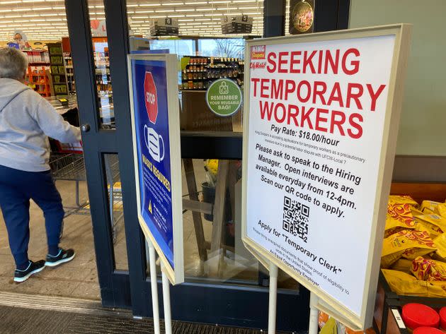 A sign advertising the need for temporary workers stands next to the entrance of a King Soopers grocery store on Jan. 6, 2022, in southeast Denver. The advertised $18 per hour for temporary workers is $2 higher than the pay floor being offered in contract negotiations. (Photo: Associated Press Photo/David ZalubowskI)