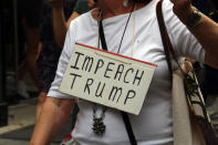 <p>A woman wears a sign reading “Impeach Trump” during an immigrations’ rights rally in New York City on June 20, 2018. (Photo: Gordon Donovan/Yahoo News) </p>