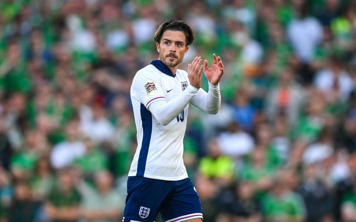 Jack Grealish claps the travelling England fans as he goes off