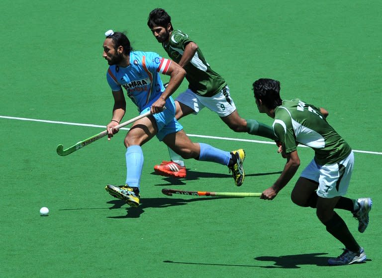Captain Sadar Singh of India (left) runs through Muhammad Waqas and Haseem Abdul Khan of Pakistan during the bronze medal match at the men's Hockey Champions Trophy tournament in Melbourne. Australia went some way to erasing the pain of their London Olympics flop by winning a record fifth consecutive Champions Trophy in a 2-1 extra-time victory over the Netherlands