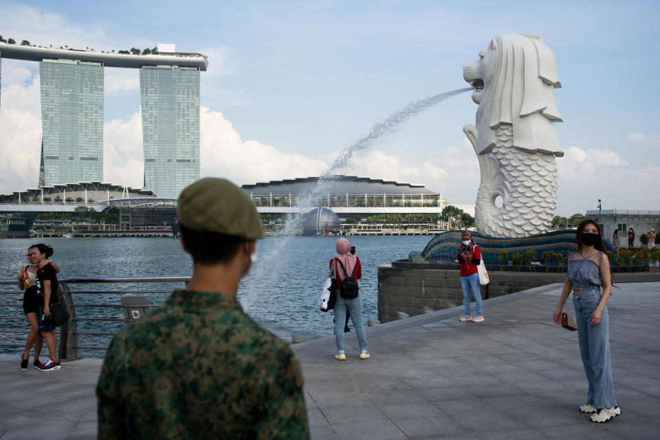 A soldier asks the public to exit the Merlion park due to the closure of the place for the Singapore National Day celebration last year.Singapore celebrated its 55th National Day on the 9th of August 2020 amid the Covid-19 pandemic. (Photo by Maverick Asio/SOPA Images/LightRocket via Getty Images)