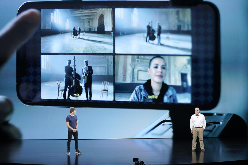 FiLMiC CTO Christopher Cohen, right, and filmmaker Sean Baker, left, explain how FiLMiC Pro utilizes all the cameras of iPhone 11 Pro during an event to announce new products Tuesday, Sept. 10, 2019, in Cupertino, Calif. (AP Photo/Tony Avelar)