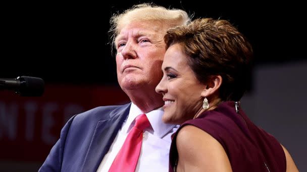 PHOTO: Former President Donald Trump embraces Republican candidate for governor Kari Lake at a 'Save America' rally in support of GOP candidates in Prescott Valley, Ariz., July 22, 2022.  (Mario Tama/Getty Images)