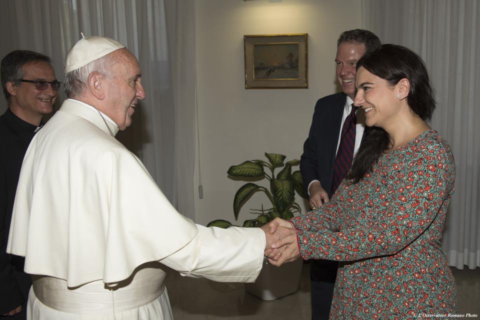 FILE - In this Monday, July 11, 2016 filer, Pope Francis greets Paloma Garcia Ovejero, right, and Greg Burke at the Vatican. The Vatican spokesman, Greg Burke, and his deputy resigned suddenly Monday, Dec. 31, 2018 amid an overhaul of the Vatican's communications operations that coincides with a troubled period in Pope Francis' papacy. In a tweet, Burke said he and his deputy, Paloma Garcia Ovejero, had resigned effective Jan. 1. (L'Osservatore Romano/Pool Photo via AP)