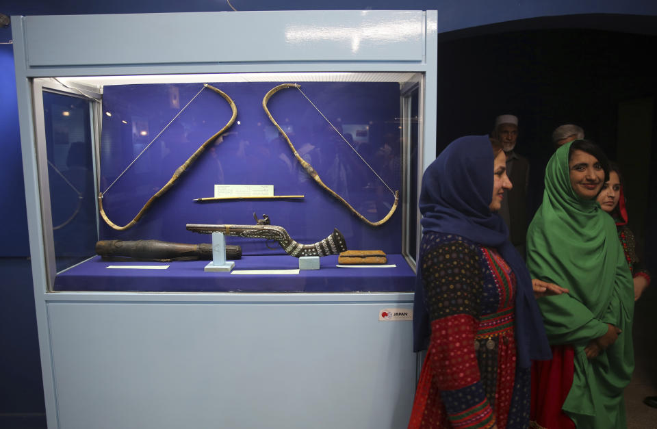 In this Saturday, Aug. 17, 2019 photo, women tour the National Museum of Afghanistan in Kabul, Afghanistan. The Taliban fighters arrived at the museum with hammers and hatred. Fragments of what they left behind have been laid out on tables, 18 years later: shattered pieces of ancient Buddha figurines smashed because they were judged to be against Islam. Now museum workers are trying to fit them together again as the Taliban and the U.S. near a deal on ending the war. (AP Photo/Rafiq Maqbool)