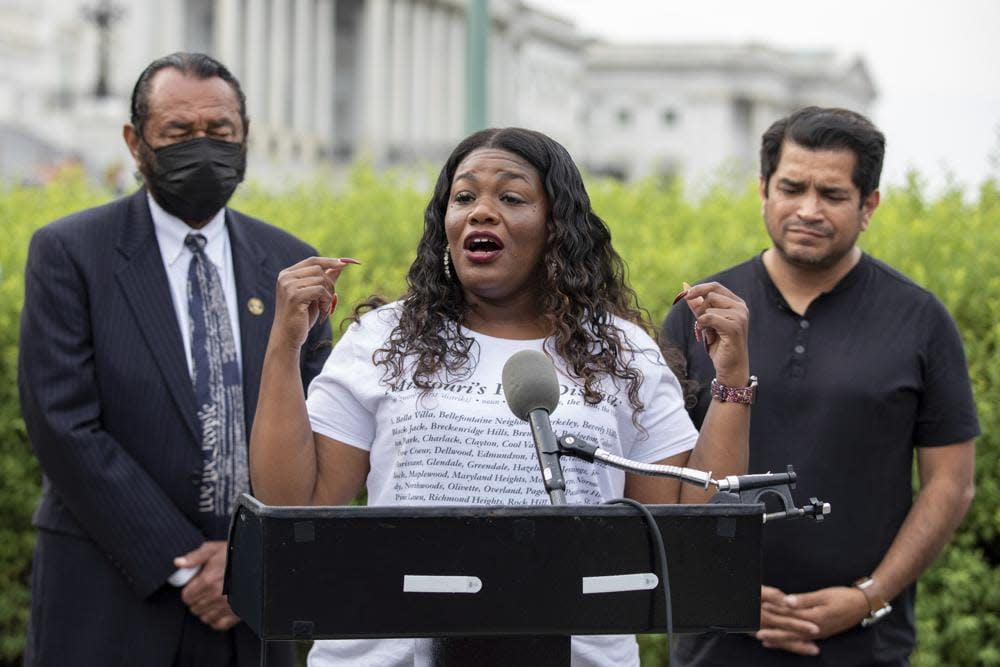 Rep. Cori Bush, D-Mo., flanked by Rep. Al Green, D-Texas, left, and Rep. Jimmy Gomez, D-Calif., right, speaks to the press after it was announced that the Biden administration will enact a targeted nationwide eviction moratorium outside of Capitol Hill in Washington on Tuesday, Aug. 3, 2021. (AP Photo/Amanda Andrade-Rhoades)