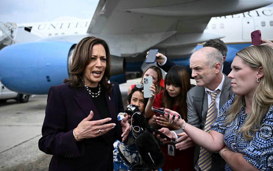 Kamala Harris speaks to reporters upon arrival at Andrews Air Force Base